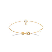 Bracelet doré chaîne avec œil orné d’un zircon et petit zircon pendant - Bijou photographié sur fond blanc 
