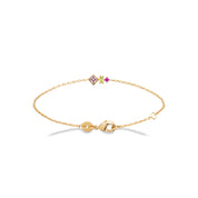 Bracelet doré avec trois zircons colorés - bijou photographié sur fond blanc 