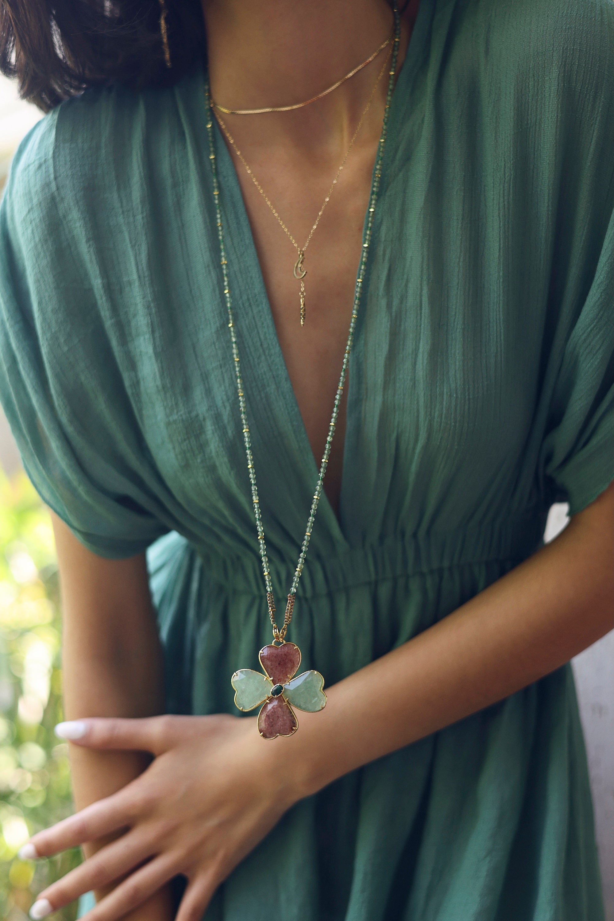 Collier sautoir Malaurie sur fil doré composé de perles en aventurine avec un pendentif en forme de trèfle serti d'aventurine, de quartz fraise et de malachite - Bijou porté
