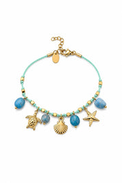 Bracelet doré Alizée pendentifs marins - Bijou sur fond blanc