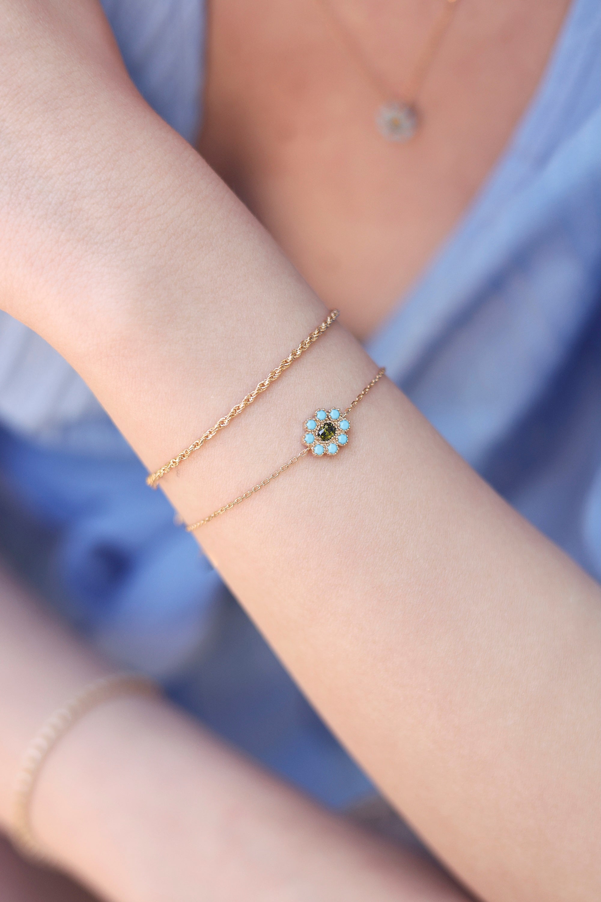 Bracelet doré Ariana orné d'une fleur sertie de zircons turquoises et verts - Bijou porté