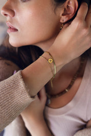 Bracelet double doré Alicia avec chaîne miroir et chaîne perlée ornée d'un pendentif médaille étoile polaire - Bijou porté
