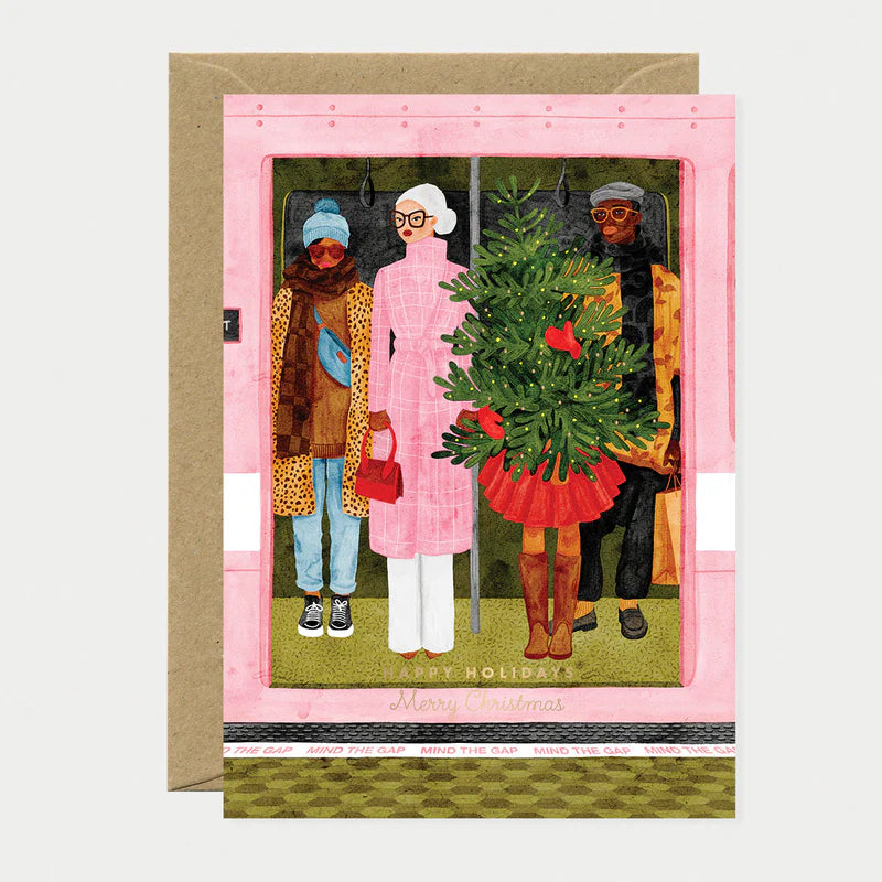 Carte de Noël en papier naturel blanc avec des gens stylés dans un metro rose dont une jeune femme portant un sapin de Noël - Papeterie