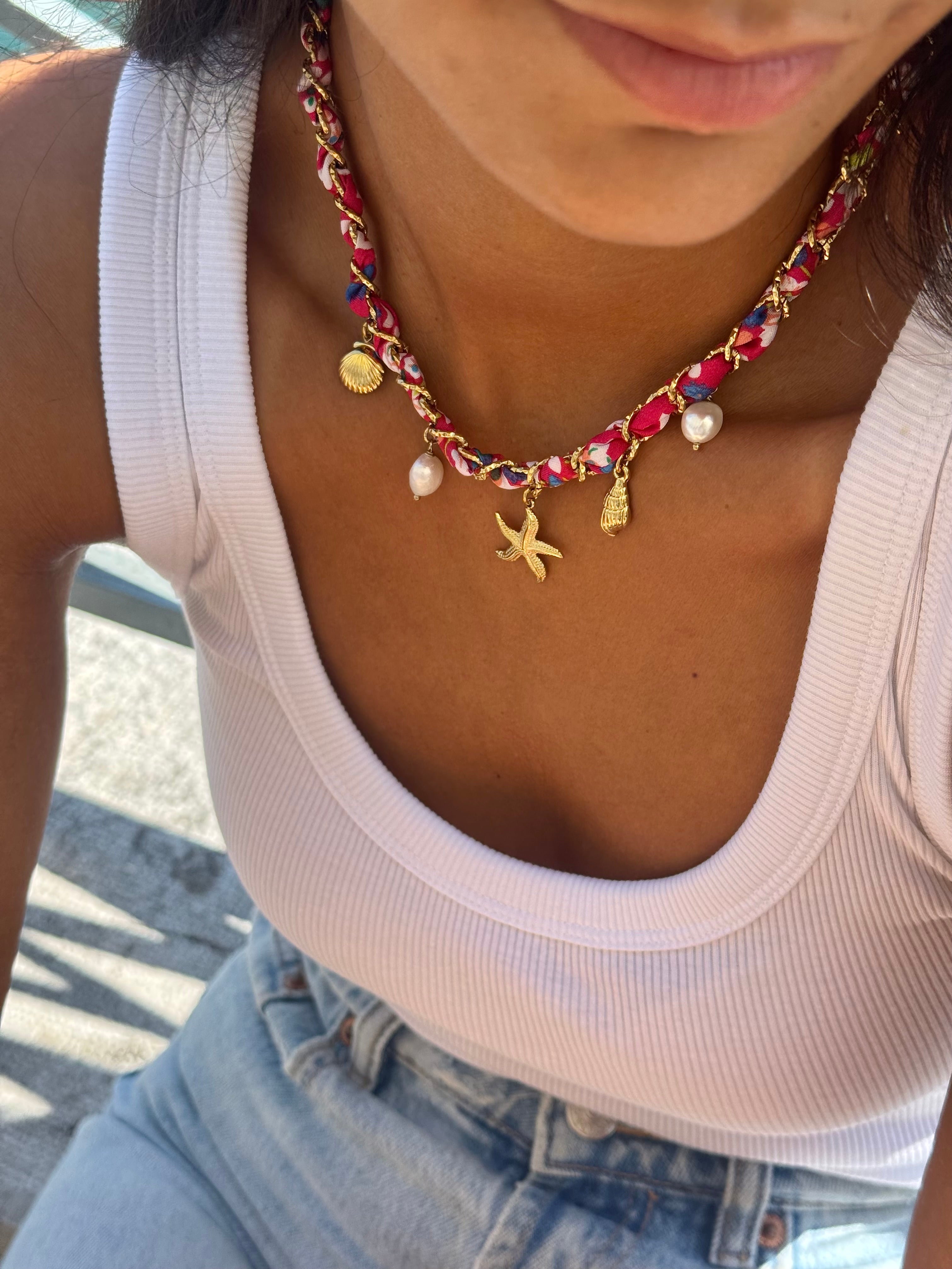 Collier doré Aminata maille entrelacée avec tissu rose fuchsia pendentifs coquillages, étoile de mer et nacres - Bijou porté