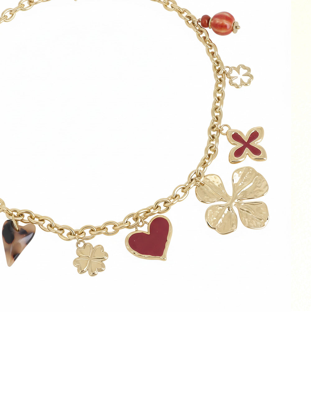 Collier doré Lounes maille avec pendentifs coeurs et trèfles - Bijou photographié sur fond blanc
