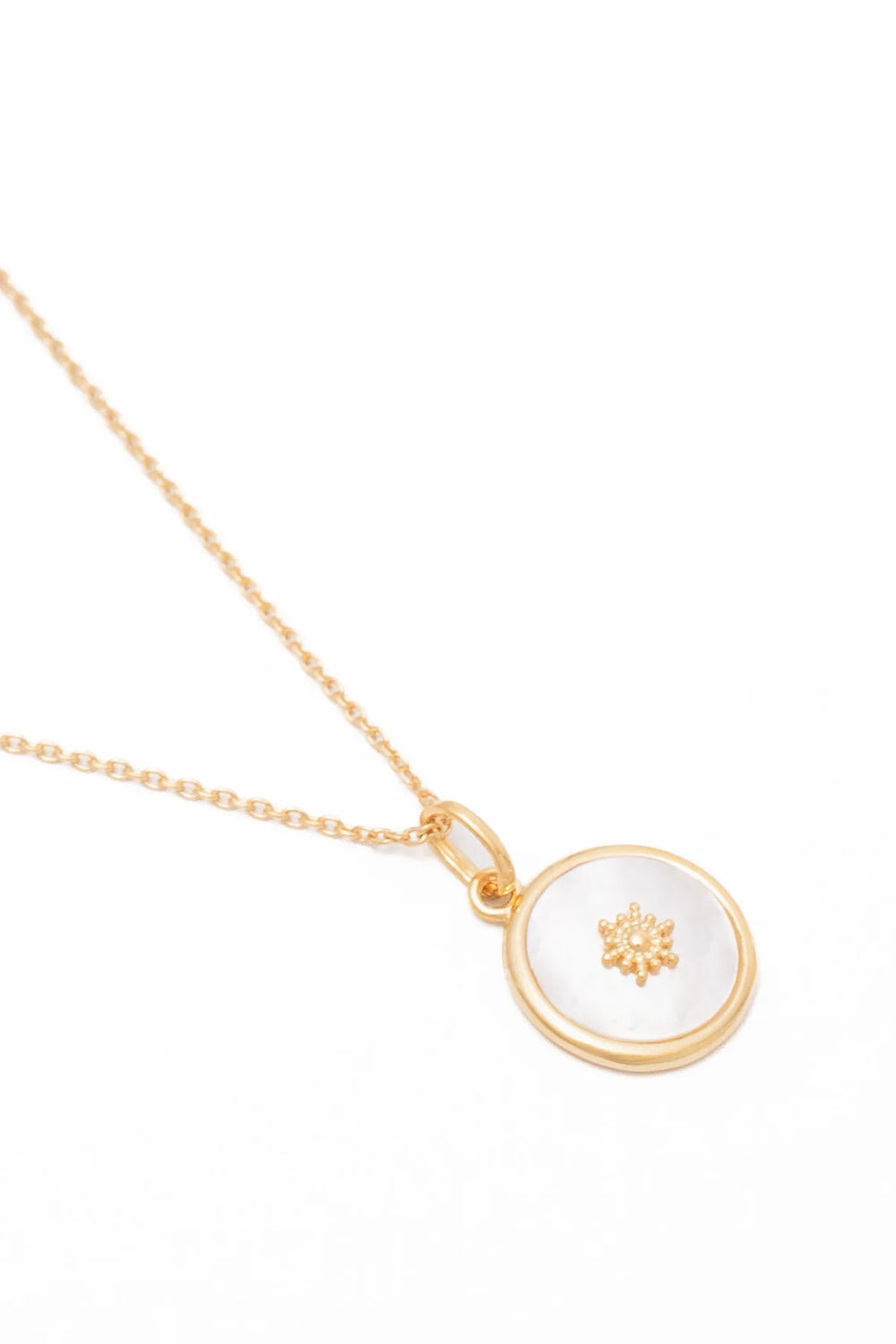Collier doré médaillon soleil et nacre - Bijou photographié sur fond blanc